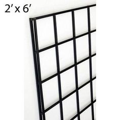 a black metal grid wall mounted to the side of a white wall