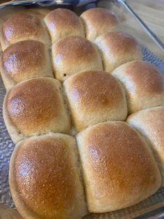 a pan filled with rolls sitting on top of a wooden table