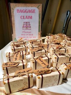 small packages of luggage claim sitting on a table next to a sign that says baggage claim