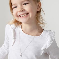 Looking for a timeless cross for an adorable little one? This understated yet elegant tiny cross necklace rests on its own matching chain, and is entirely crafted of sterling silver making it suitable for those with sensitive skin. This tiny cross comes neatly packaged in its own little gift box for your convenience. Age Group: Elegant for Babies, Infants, Young Girls & Preteens (0-12 years); Safe for Sensitive Skin Material: 925 Sterling Silver Cross Size: 9mm W x 12mm H polished plain cross Me Tiny Cross Necklace, Girls Necklace, Tiny Cross, Girls Necklaces, Sterling Silver Cross, Toddler Kids, Religious Jewelry, Silver Cross, Infants