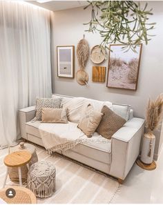 a living room filled with furniture and pictures hanging on the wall next to a window