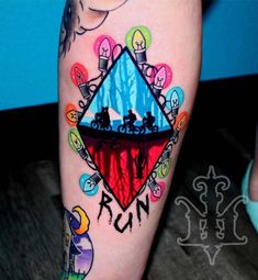 a colorful tattoo on the leg of a woman