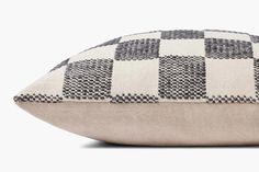 a black and white checkered pillow sitting on top of a table