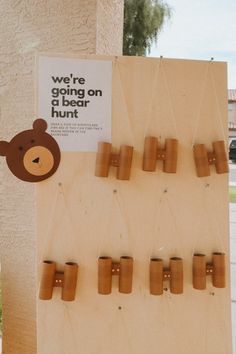 there is a sign that says we're going on the bear hunt with wooden pegs attached to it