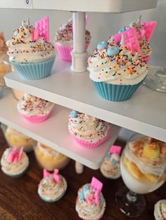 cupcakes and other pastries are displayed on shelves