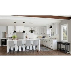 an open kitchen with white cabinets and bar stools next to the dining room table