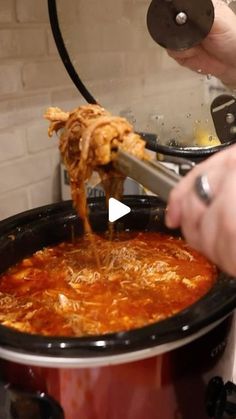 a person pouring sauce into a slow cooker