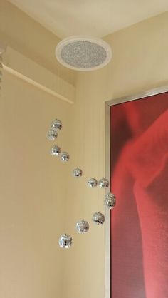 a bath room with a toilet and a shower head mounted to the side of a wall