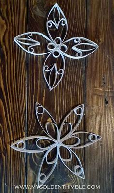 two metal flowers on a wooden surface