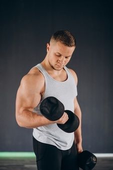 a man holding two black dumbs in his hands