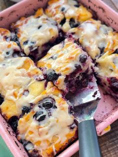 a close up of a pan of food with blueberries and cheese on it,