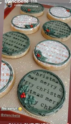 cookies decorated with christmas sayings are on a cookie sheet