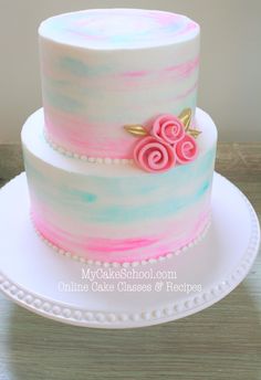 a cake with pink and blue frosting on top is shown in the instagramture