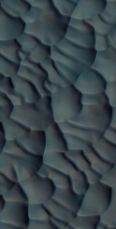 an abstract photo of water ripples on the surface in blue and grey tones,