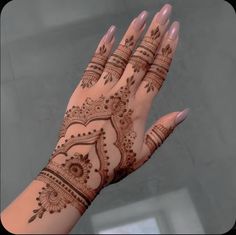 a woman's hand with henna on it