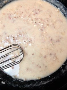 the food is being cooked in the skillet with some whisk on top