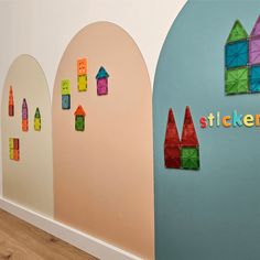 there are three walls with different shapes and sizes on them, one is made out of colored paper