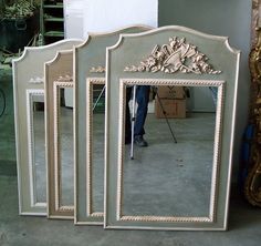 a man standing in front of a large mirror