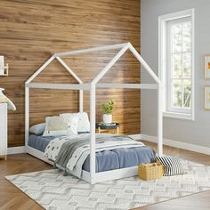 a white bed sitting in a bedroom on top of a hard wood floor