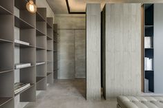 an empty room with bookshelves and a bench