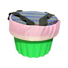 a green cupcake with a pink and blue cover on it