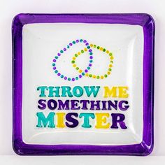 a purple and white plate with the words throw me something mister written in multicolored letters