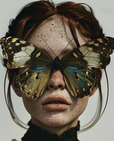 a woman with freckles on her face and butterfly wings