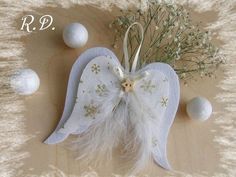 an angel ornament with feathers and flowers