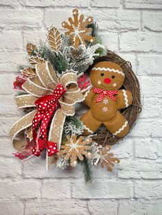 a wreath with a gingerbread man and snowflakes