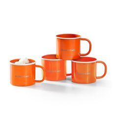 four orange coffee mugs stacked on top of each other