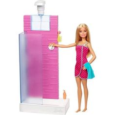 a barbie doll is standing next to a pink water fountain with a blue towel on it's arm