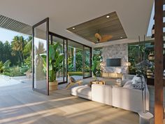 a living room filled with furniture next to a swimming pool