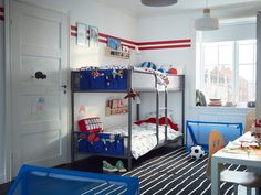 a bedroom with two bunk beds and blue chairs in it, next to a window