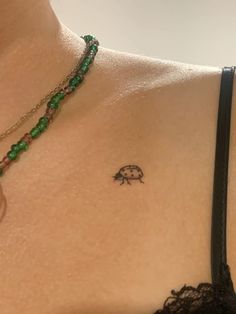 a close up of a woman's chest with a tattoo on her left side