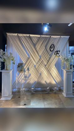 an image of a stage set up for a wedding ceremony with flowers on the side