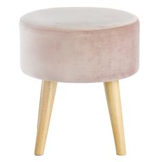 an upholstered stool with wooden legs and a light pink velvet cover on top