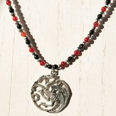 Be the Mother of Dragons with this Game of Thrones necklace featuring the House Targaryen three-headed dragon sigil. Perfect for finishing out your Halloween or cosplay costume. Includes FREE gift bag. Dragon Sigil, Game Of Thrones Necklace, The Mother Of Dragons, House Targaryen, Mother Of Dragons, Black Seed, Character Ideas, Beaded Material, Red Crystals