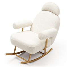 a white rocking chair with gold legs