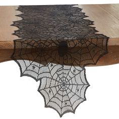 a wooden table topped with a spider web net