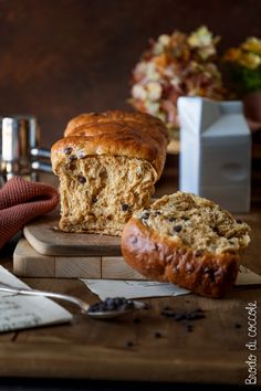 a loaf of bread sitting on top of a wooden cutting board next to a knife