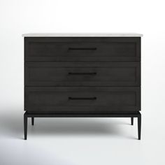 a black dresser sitting on top of a white floor