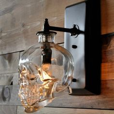 a light that is on the wall with a skull head in it's mouth