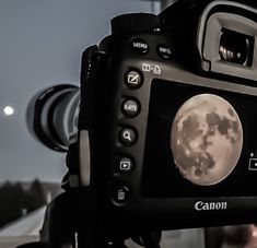 a camera with a full moon in the background