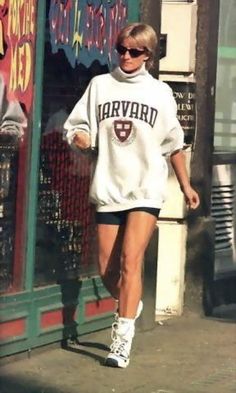 a woman walking down the street in front of a store