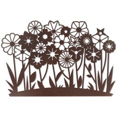 a metal cutout of flowers and grass