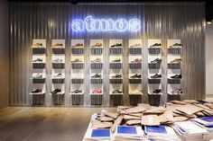 the inside of a shoe store with stacks of shoes on display in front of it