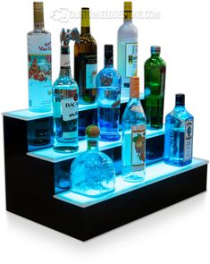 an illuminated shelf with many different bottles on it