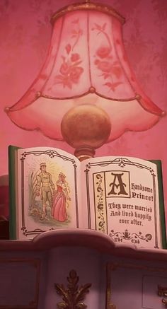 a lamp that is sitting on top of a book shelf in front of a pink wall