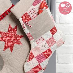 a quilted christmas stocking hanging on a brick wall