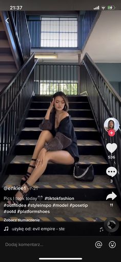 a woman is sitting on the stairs talking on her cell phone